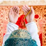 Asian Muslim woman praying with beads chain