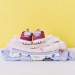 newborn-concept-with-pile-clothes_23-2147665656
