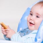 happy-toddler-eating-cookie_186202-185