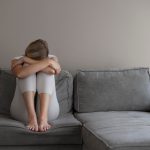 full-shot-woman-sitting-couch_23-2149071929